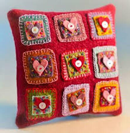 Picture of embellished hearts on pillow.